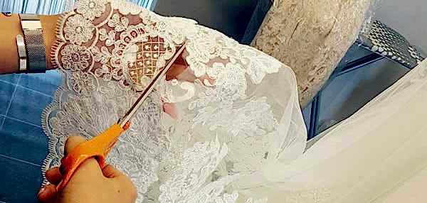 Cutting fabric at Laima Bridal.